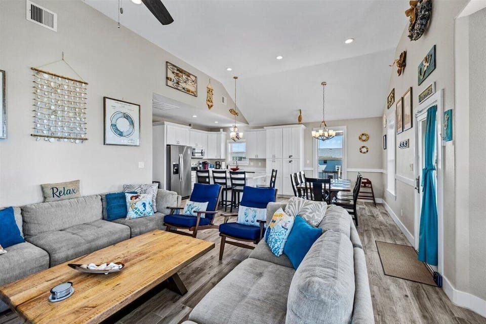 Open floor plan living space featuring comfortable seating, coffee table, and easy access to dining and kitchen areas.