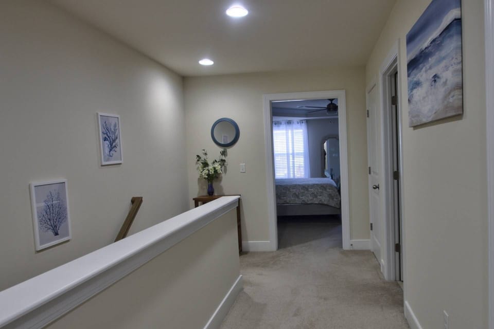 Second floor landing leading to 3 bedrooms and two bathrooms with laundry