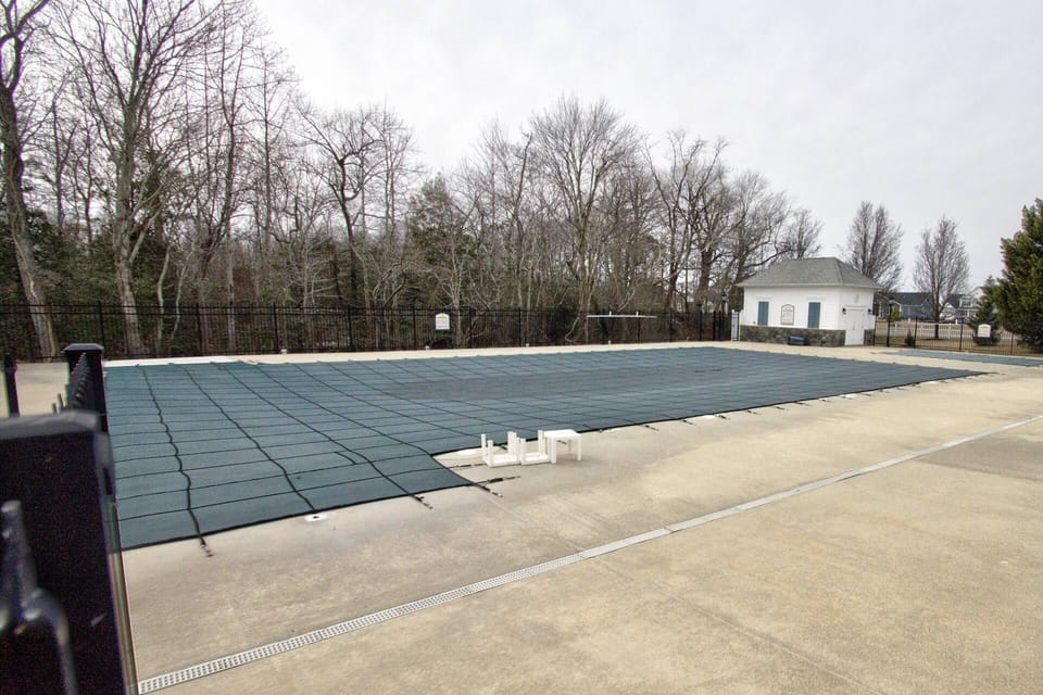 Community Pool with Club House and Plenty of Chairs