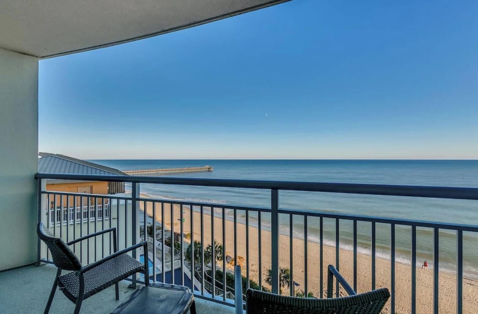 Private balcony with breathtaking ocean views, cozy seating, and a perfect spot 
