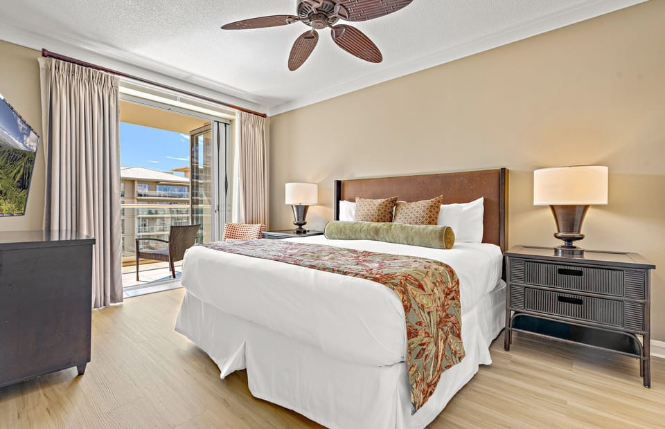 Cozy primary bedroom with a king bed and soft natural light, perfect for unwinding after a day on Kaanapali Beach.
                