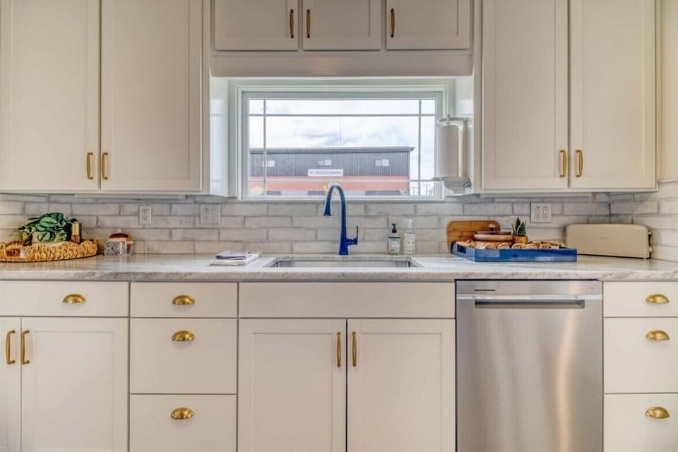 Clean, functional kitchen workspace with ample cabinetry,  and prep space.