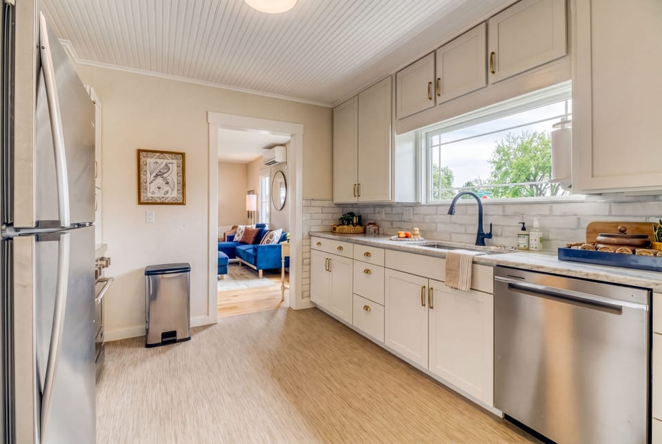 Bright, fully stocked kitchen with updated appliances, plenty of prep space, and