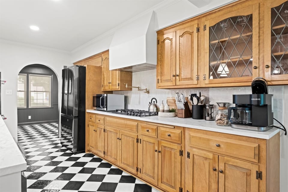 Fully equipped main-level kitchen with gas range, generous cabinetry, and plenty of prep space. Designed for hosting family dinners and extended stays.