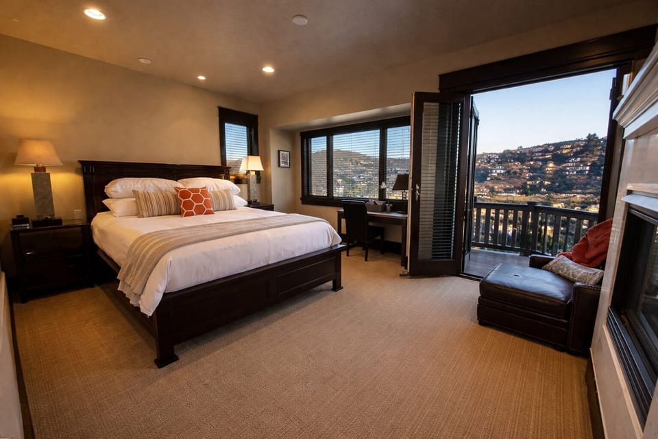 Wake up to sweeping Old Town views in this spacious second-level primary suite, featuring a plush bed and direct access to a private balcony.