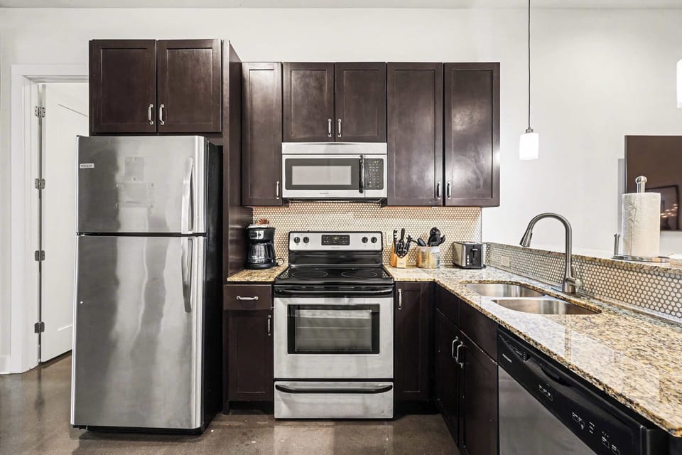 Cook like a pro in this modern kitchen with stainless appliances and sleek granite counters.