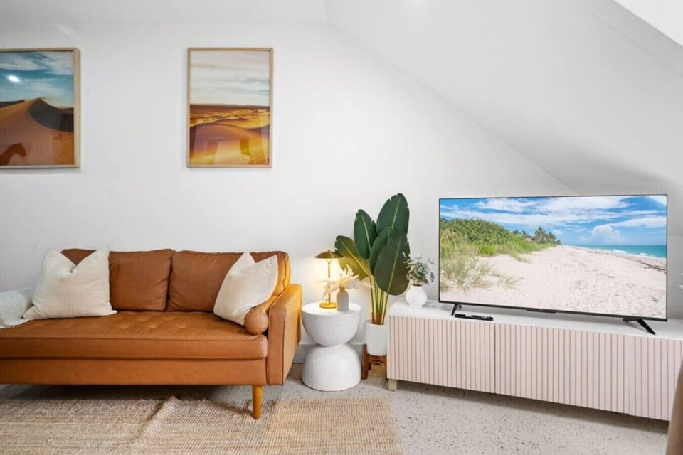 Sun-filled living space with warm designer touches — perfect for relaxing after a day in the city.