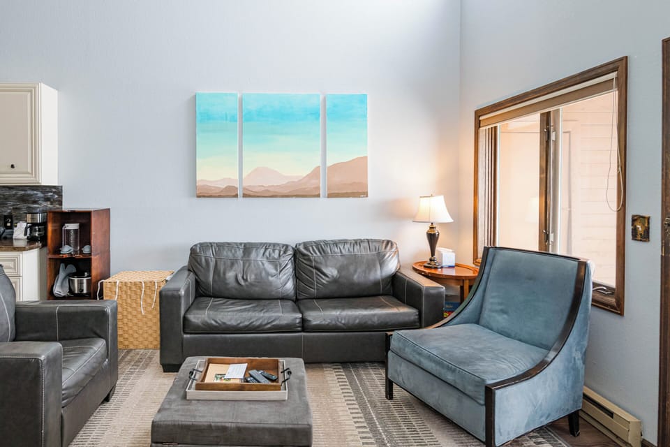 Sink into plush leather seating in 643 SilverCreek Inn your stylish living space, where mountain artwork and warm lighting create the perfect atmosphere for unwinding.