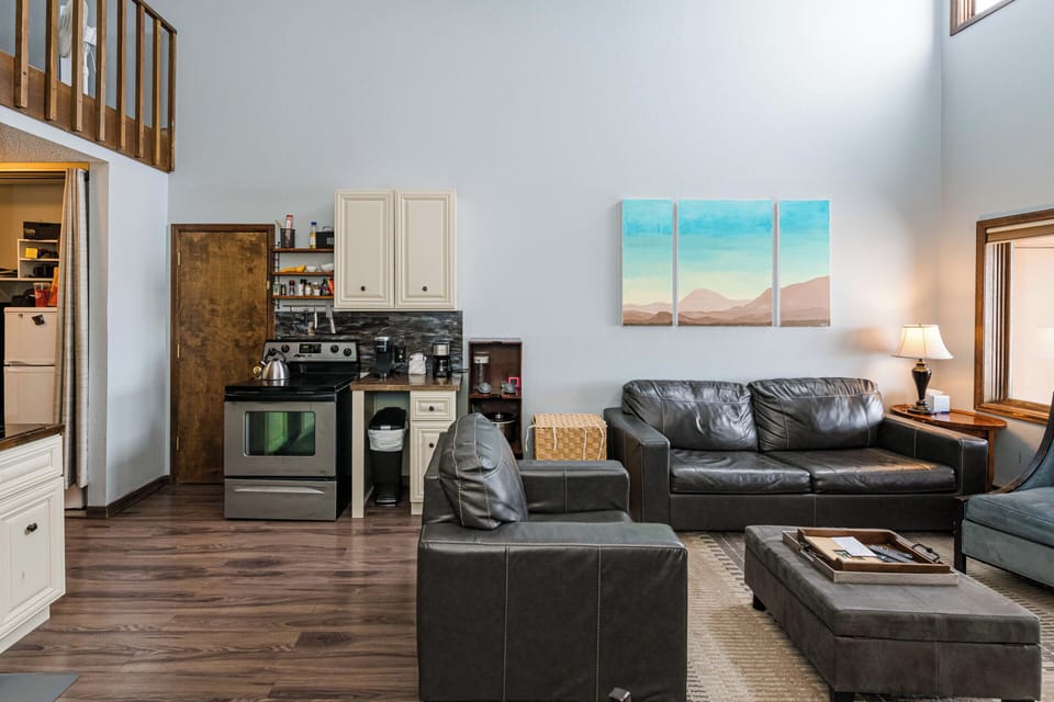 Sink into plush leather seating at 643 SilverCreek Inn in your open-concept living space, where the kitchen flows seamlessly into your relaxation area.