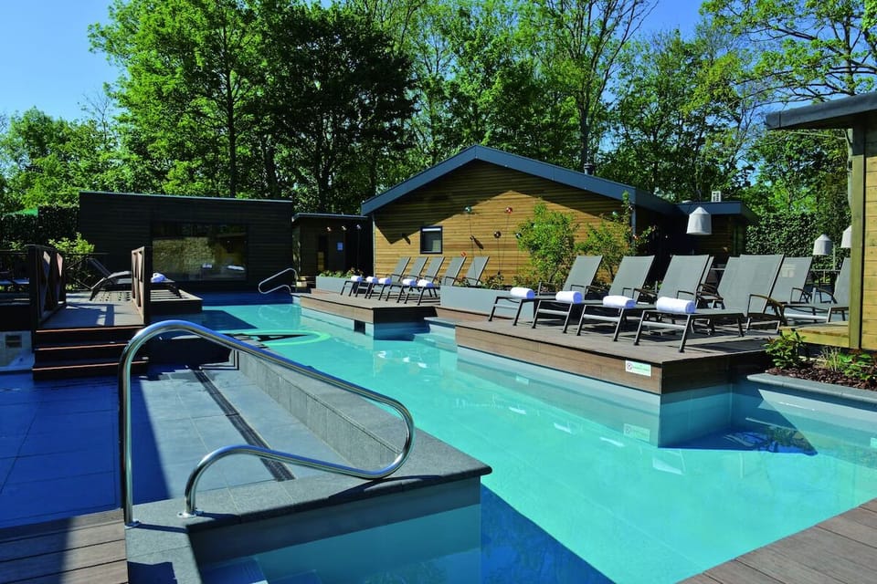 Dive into sunlit serenity by the sleek outdoor pool deck