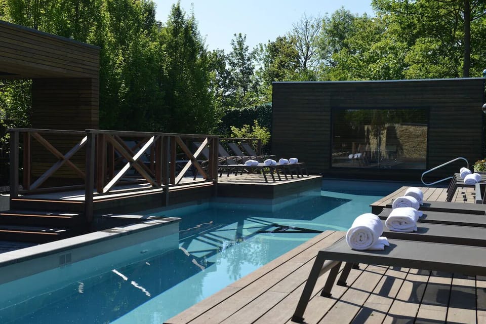 Relax poolside with plush towels and calm waters at sunset