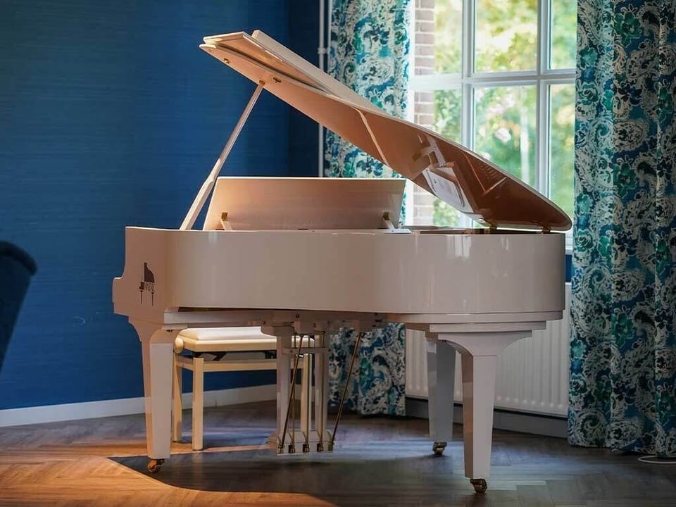Play a few notes on the grand piano by daylight.