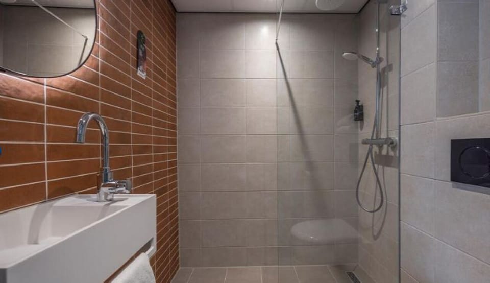 Rinse off in a clean, modern shower after a long day.