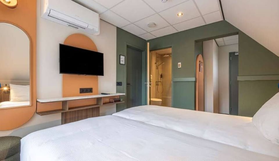Settle in for a cozy night with TV and easy ensuite access.