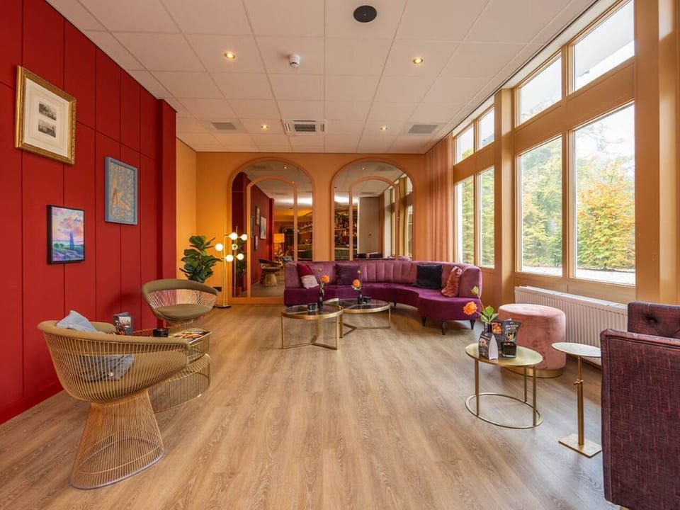 Unwind in a stylish lounge with warm, golden light.