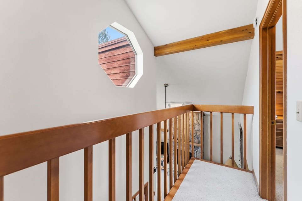 Ascend the charming staircase with warm wood railings and discover the upper level of your retreat.