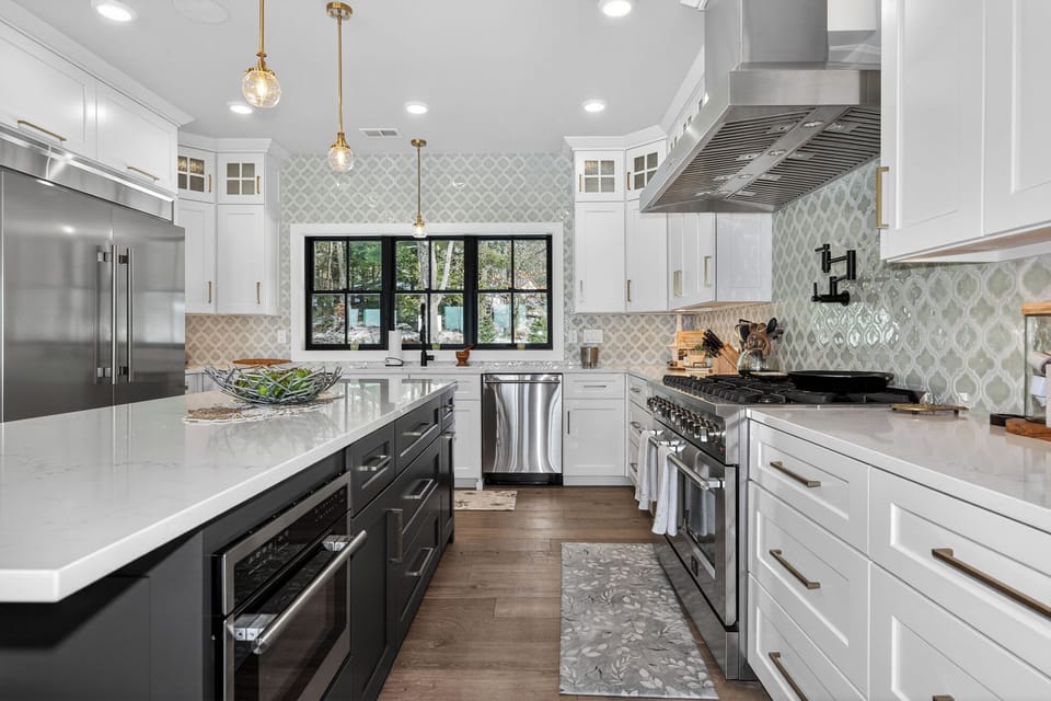 Prepare memorable meals in this gorgeous kitchen featuring gleaming quartz countertops, premium appliances, and elegant pendant lighting.