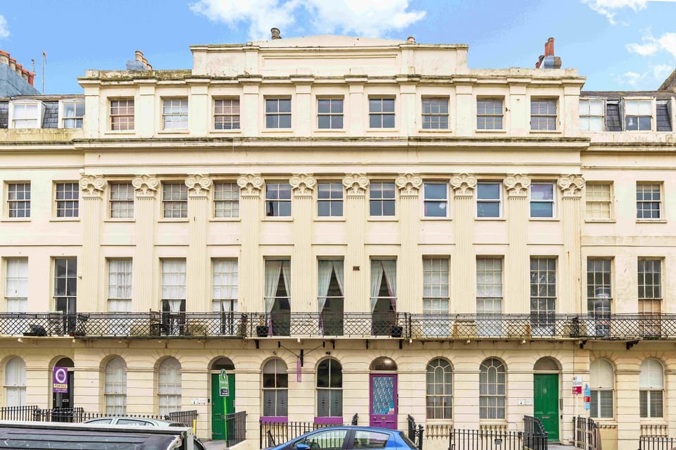 Elegant exterior of a three-storey Brighton home with classic street appeal.
