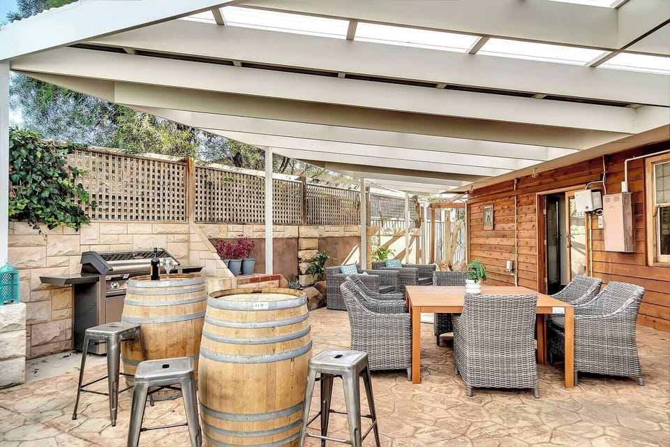 Gather on the covered patio for alfresco dining, where outdoor furniture and the BBQ set the scene for casual meals and laid-back evenings.