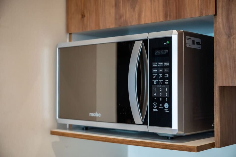 Fully equipped kitchen with modern appliances, including a microwave for quick and easy meals.