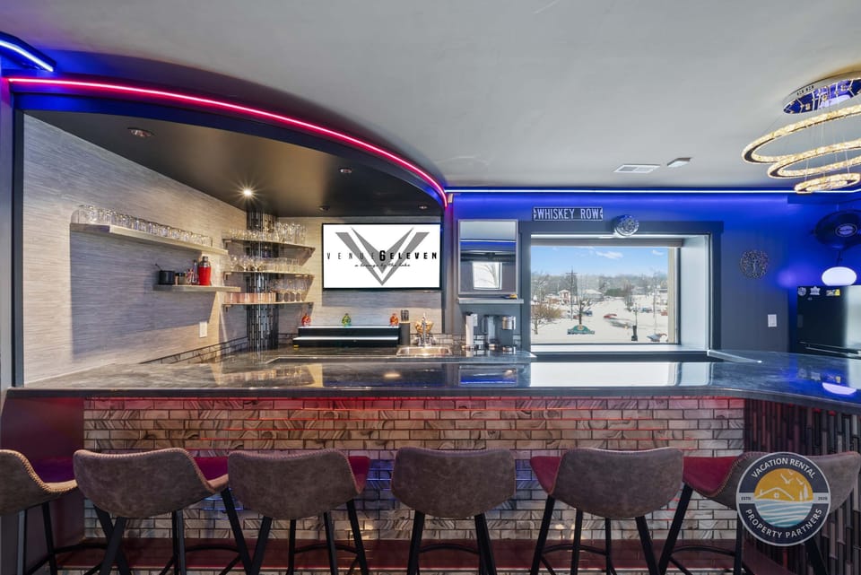 Neon-lit bar counter with stools