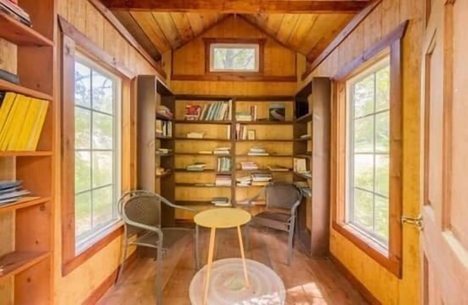 The Reading Hollow with shelves and sun-filled windows on both sides