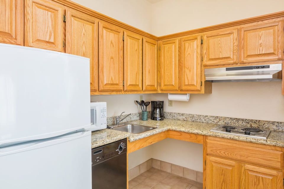 Cook with ease in a fully equipped kitchen featuring modern appliances and ample storage.