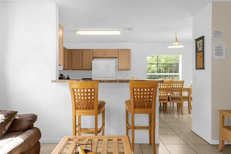 Breakfast Bar that Seats 2 People with Kitchen in Background