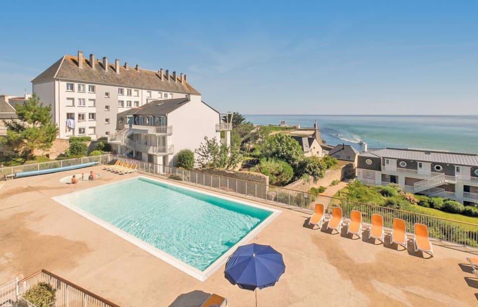 Take a refreshing dip in the sparkling pool surrounded by lounge chairs and stunning ocean views.