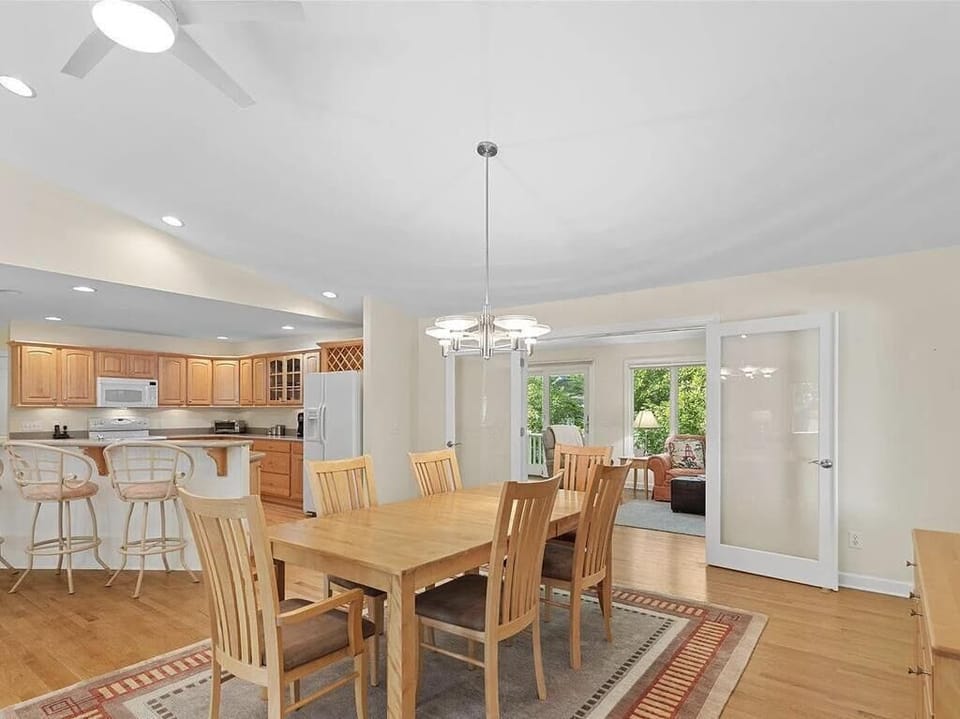 Gather around the dining table, where warm wood tones invite lively meals and cherished memories.