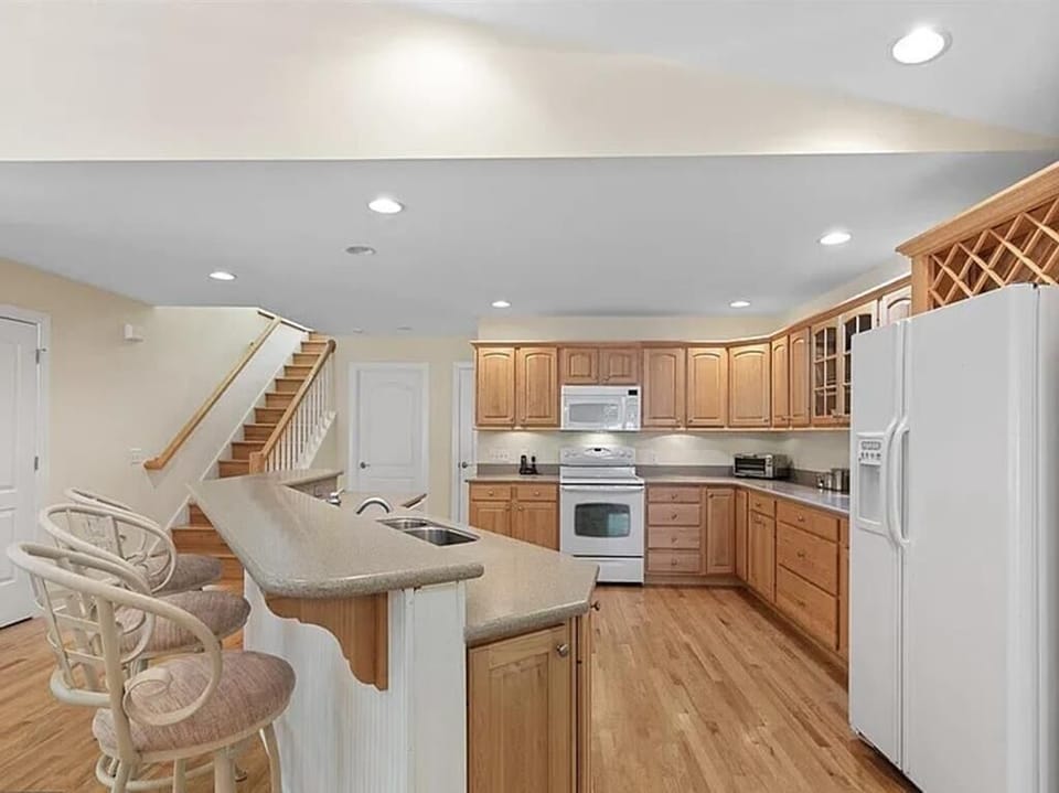Enjoy the clean lines and bright ambiance of a fully equipped kitchen, ready for your culinary adventures.