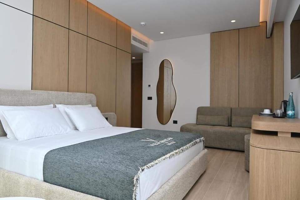 Junior Suite, Balcony, Ground Floor | Minibar, in-room safe, desk, blackout drapes