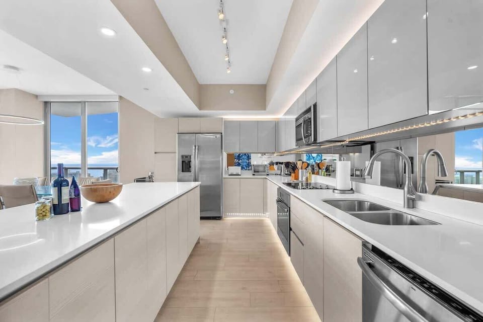 Fully equipped gourmet kitchen with stainless steel appliances, sleek cabinetry, and a spacious island perfect for cooking and entertaining.