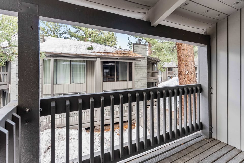 Relaxing balcony with snowy pine views.