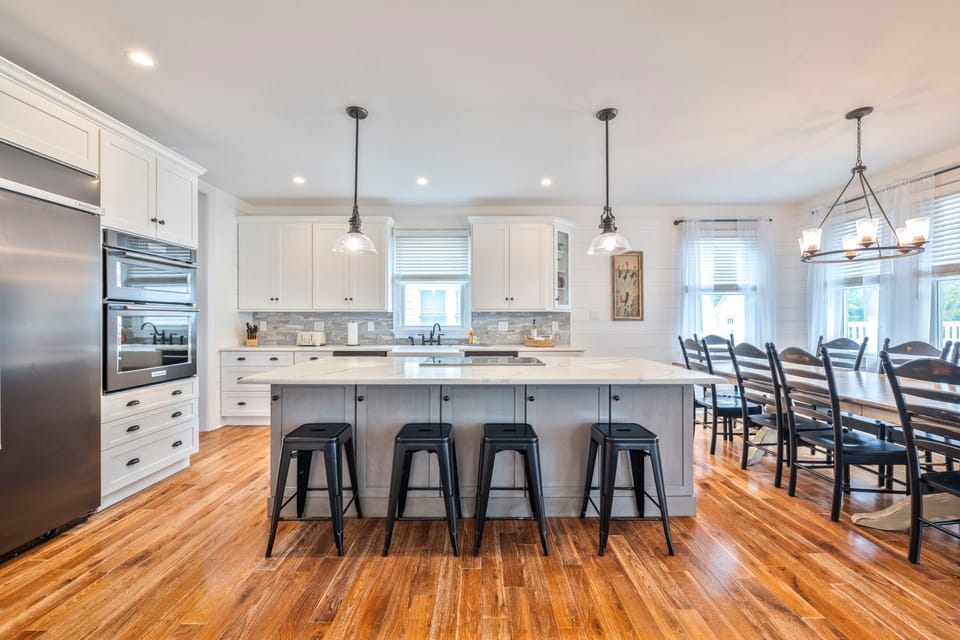Gather around the spacious kitchen island, perfect for sharing morning coffee or planning dinner.