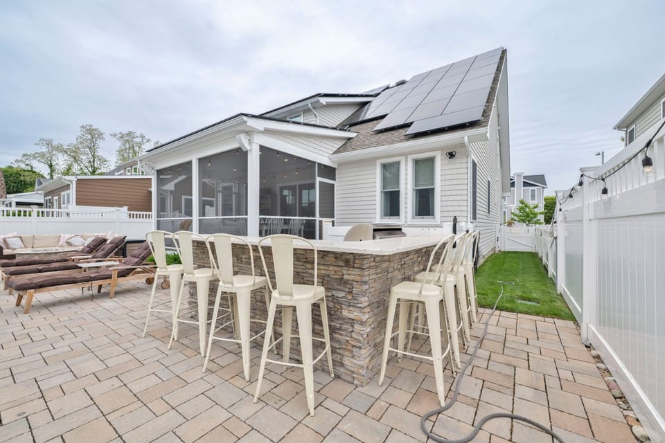 Gather around the stylish outdoor kitchen and enjoy the lively atmosphere of backyard get-togethers.