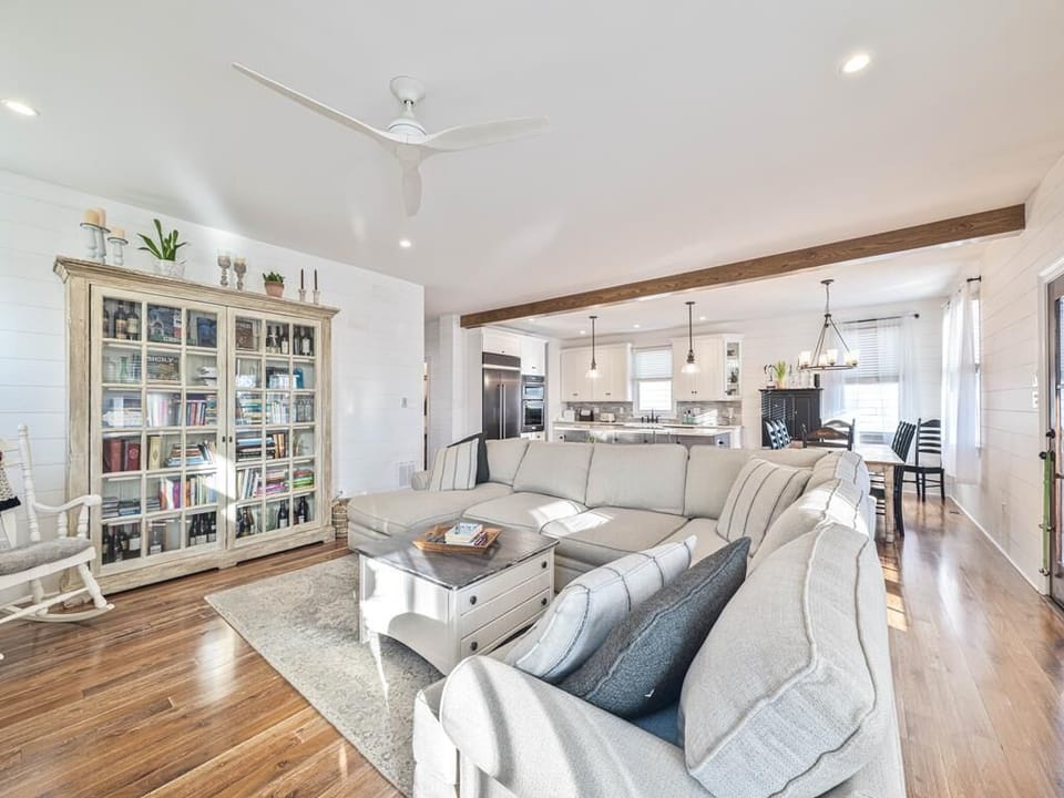 Relax in the sunlit living area, where cozy seating invites you to unwind with friends and family.