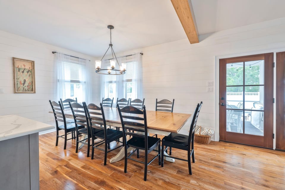 Dine with a view in this charming space, featuring large windows and a beautiful wooden table for family feasts.