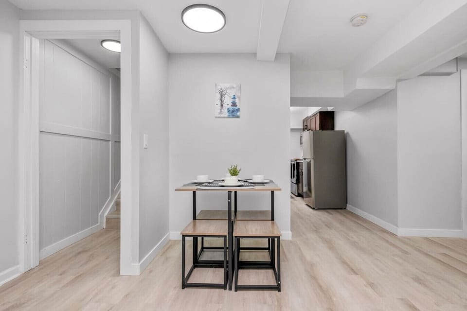Clean and open hallway leading to a cozy dining space and kitchen area.