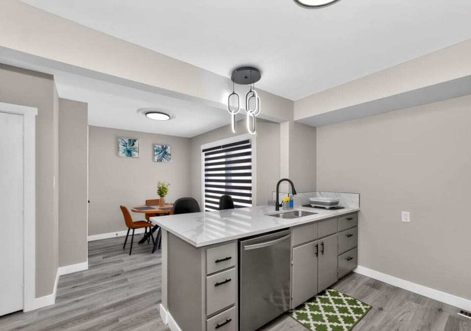 Modern open-concept kitchen and dining area with island seating and bright contemporary finishes.