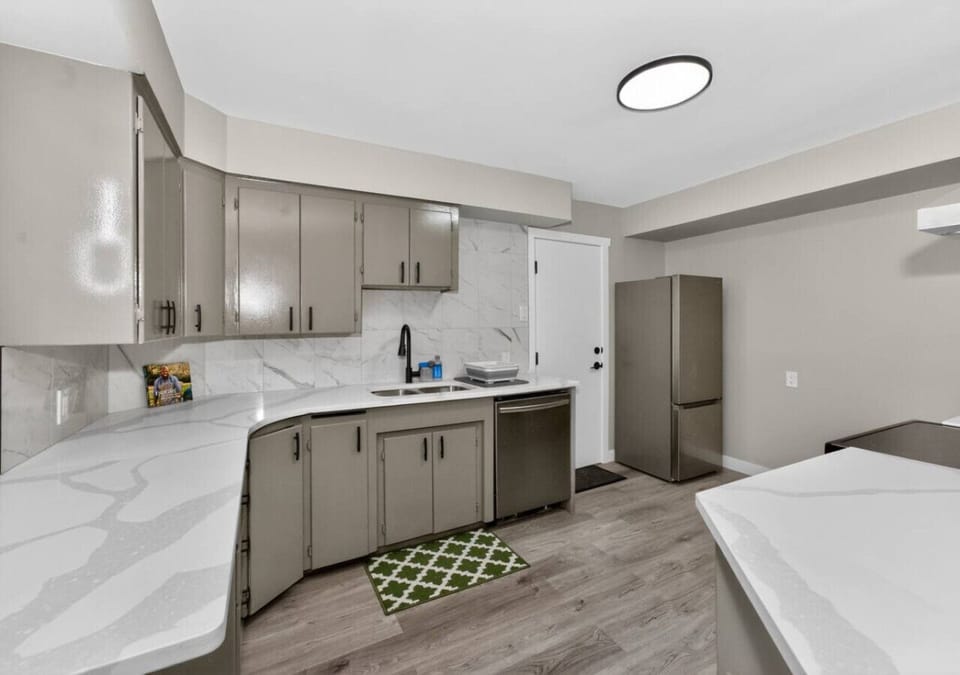 Modern kitchen with quartz countertops, ample cabinets, and full-size appliances.