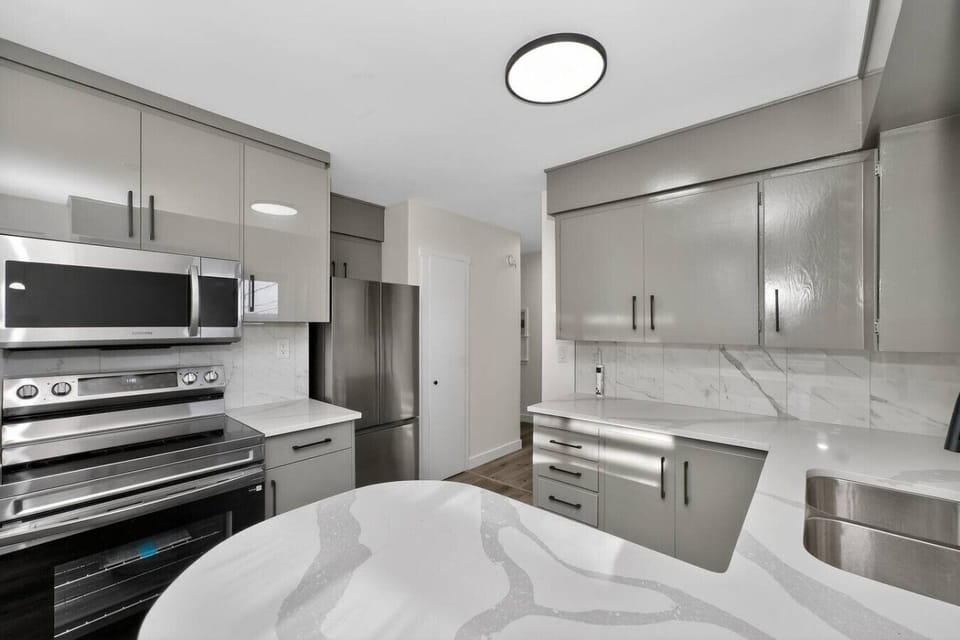 Bright kitchen with ample cabinetry and full-size appliances.