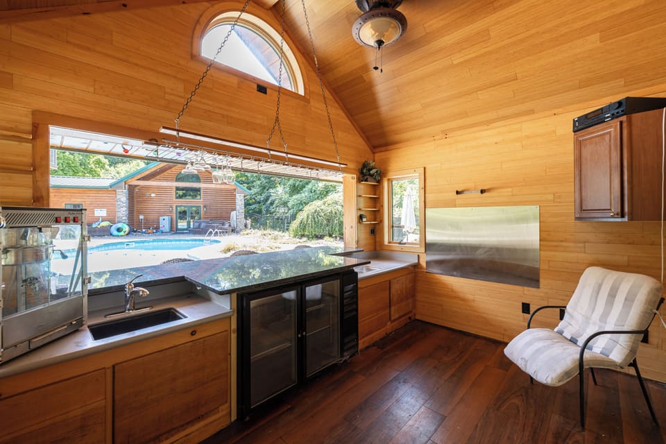 Wood-paneled kitchenette overlooking the pool area