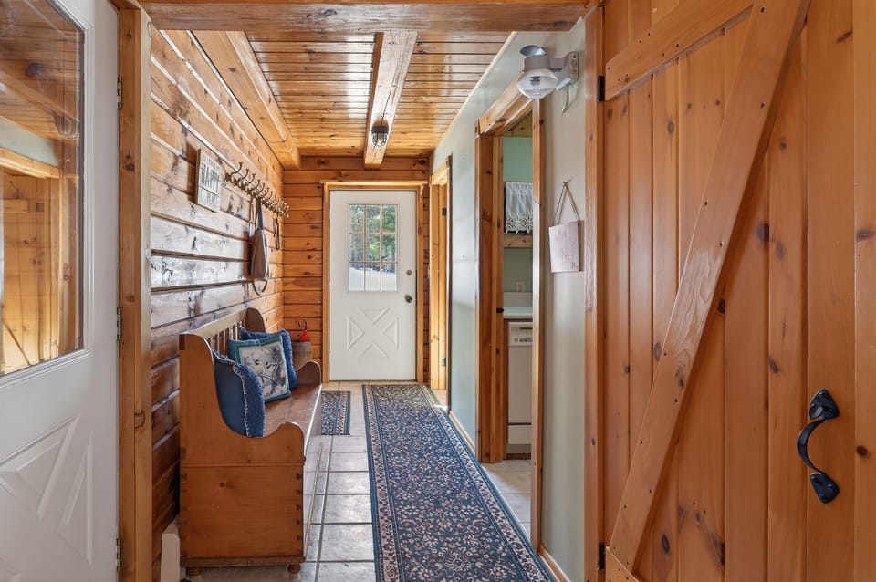 Wood-paneled entry hallway with exterior door