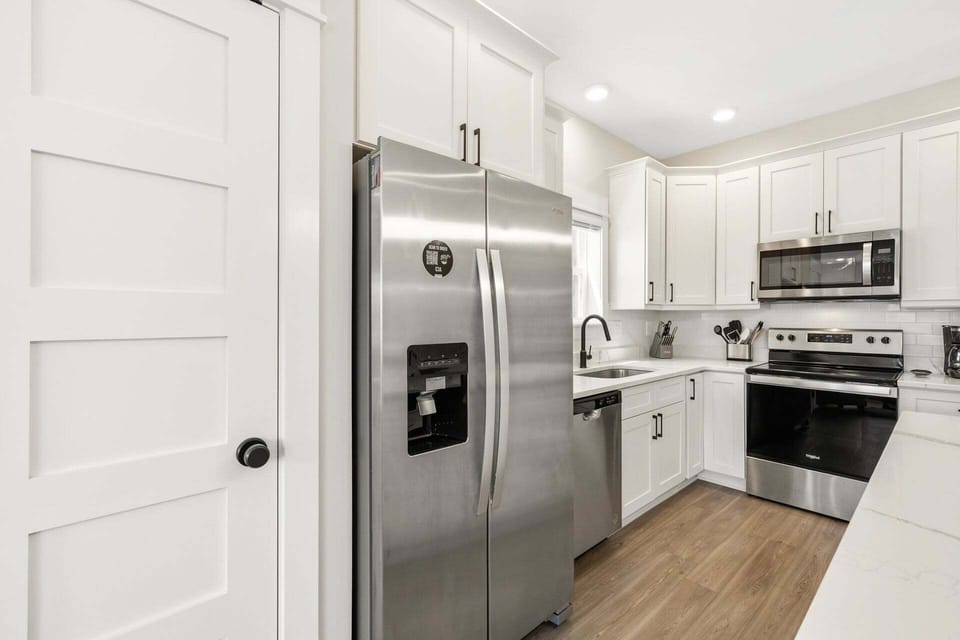Kitchen: Modern appliances, sleek finishes, and a breakfast bar for easy meal prep and casual dining.