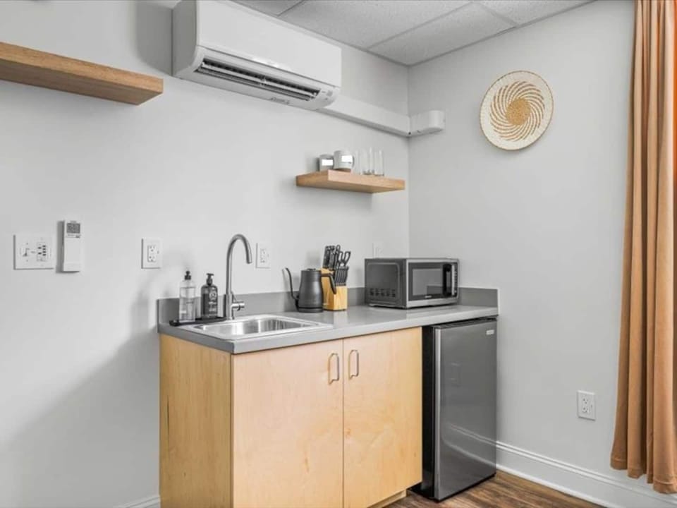 Bright, minimalist kitchenette stocked with essentials for easy, comfortable stays.