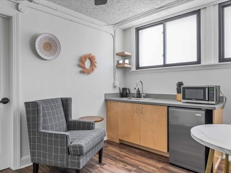 Cozy kitchenette with modern essentials and a comfy lounge spot for unwinding.