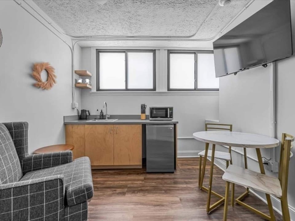 “Cozy kitchenette with modern essentials and a comfy lounge spot, kitchen tables and chairs for unwinding.