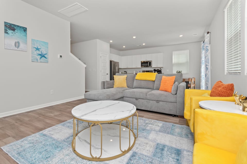 Modern open living space with cozy seating and bright coastal accents