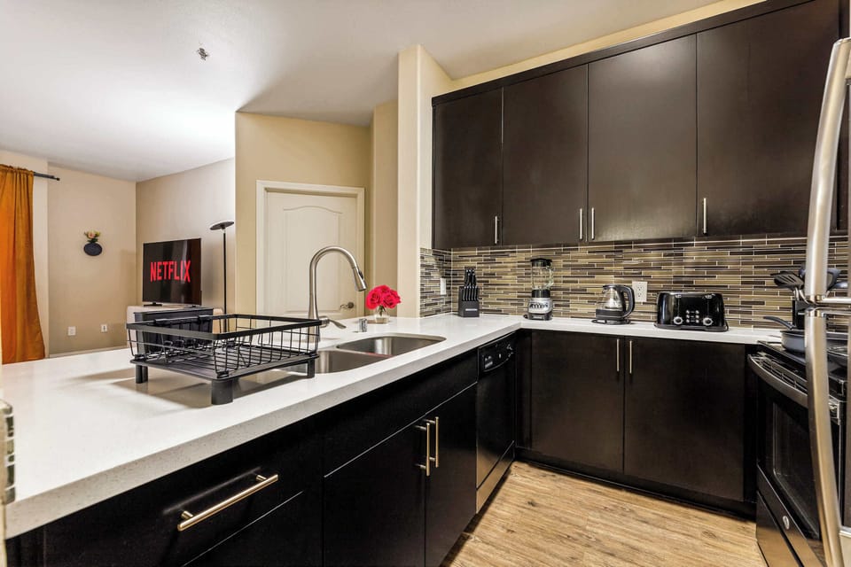 Open kitchen layout with a large counter, perfect for cooking, serving, or enjoying a quick meal.
